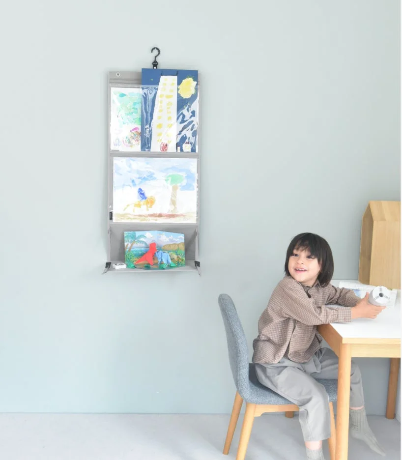 子供部屋でウォールポケットを見る男の子