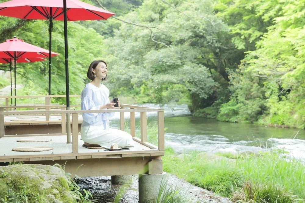 緑豊かな自然に囲まれた川沿いのテラス席