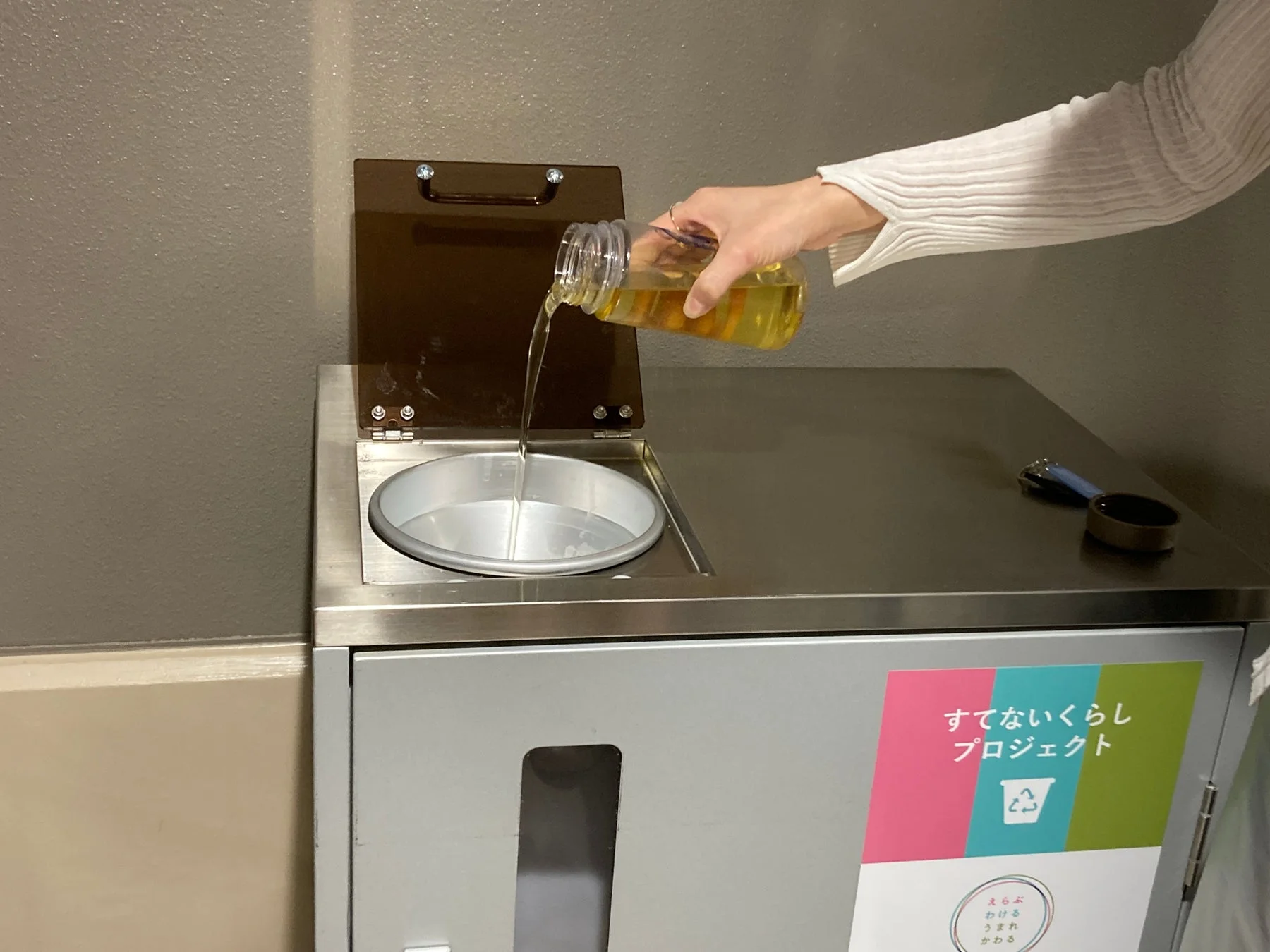廃食油を回収ボックスに注ぐ様子
